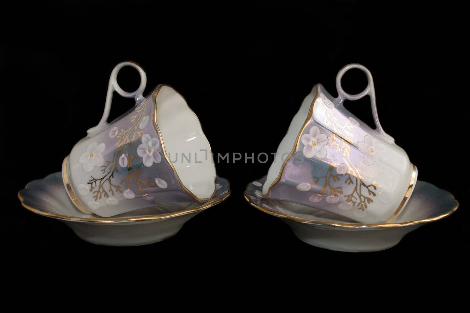 porcelain cup and saucer on a black background