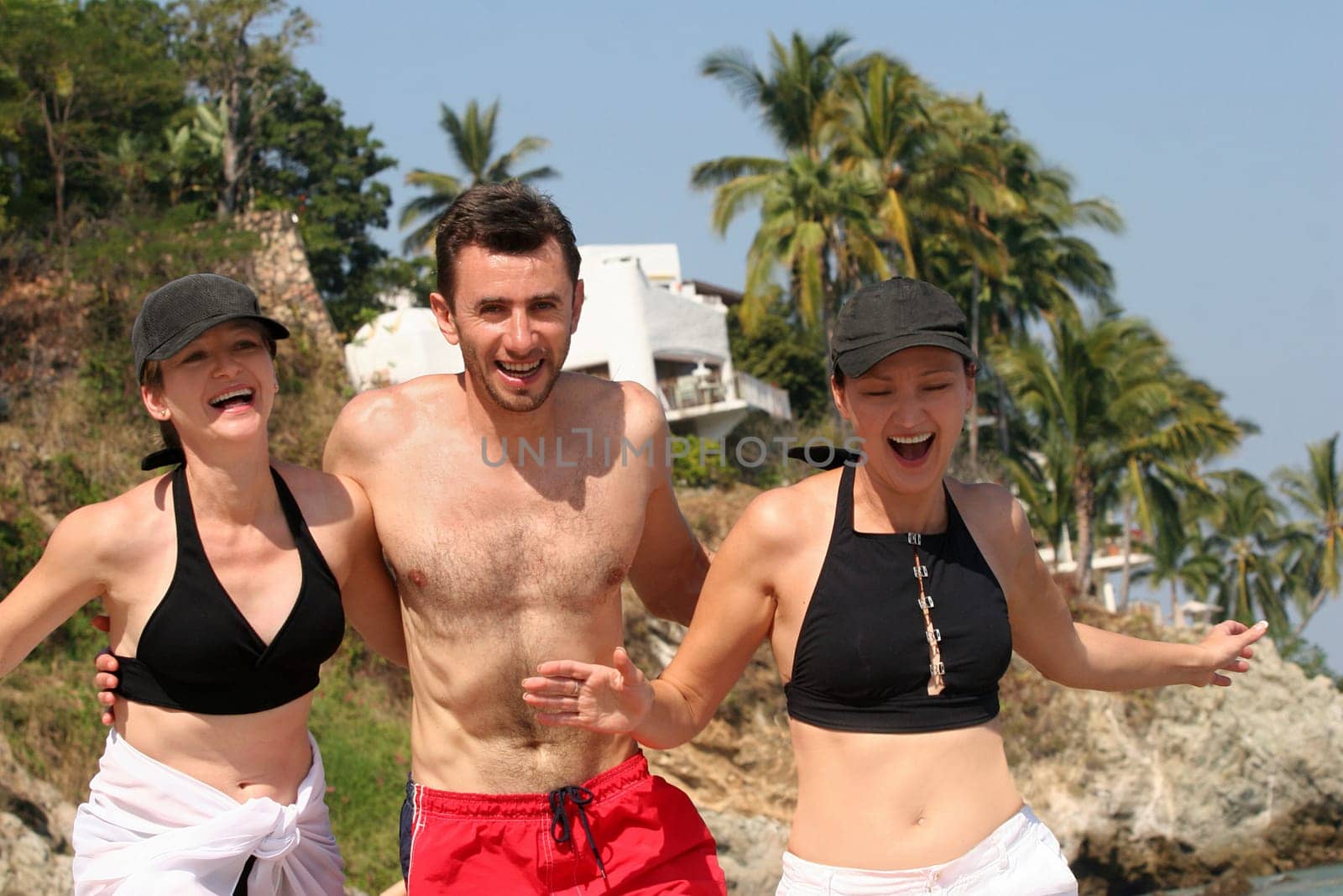 Young people running on the beach
