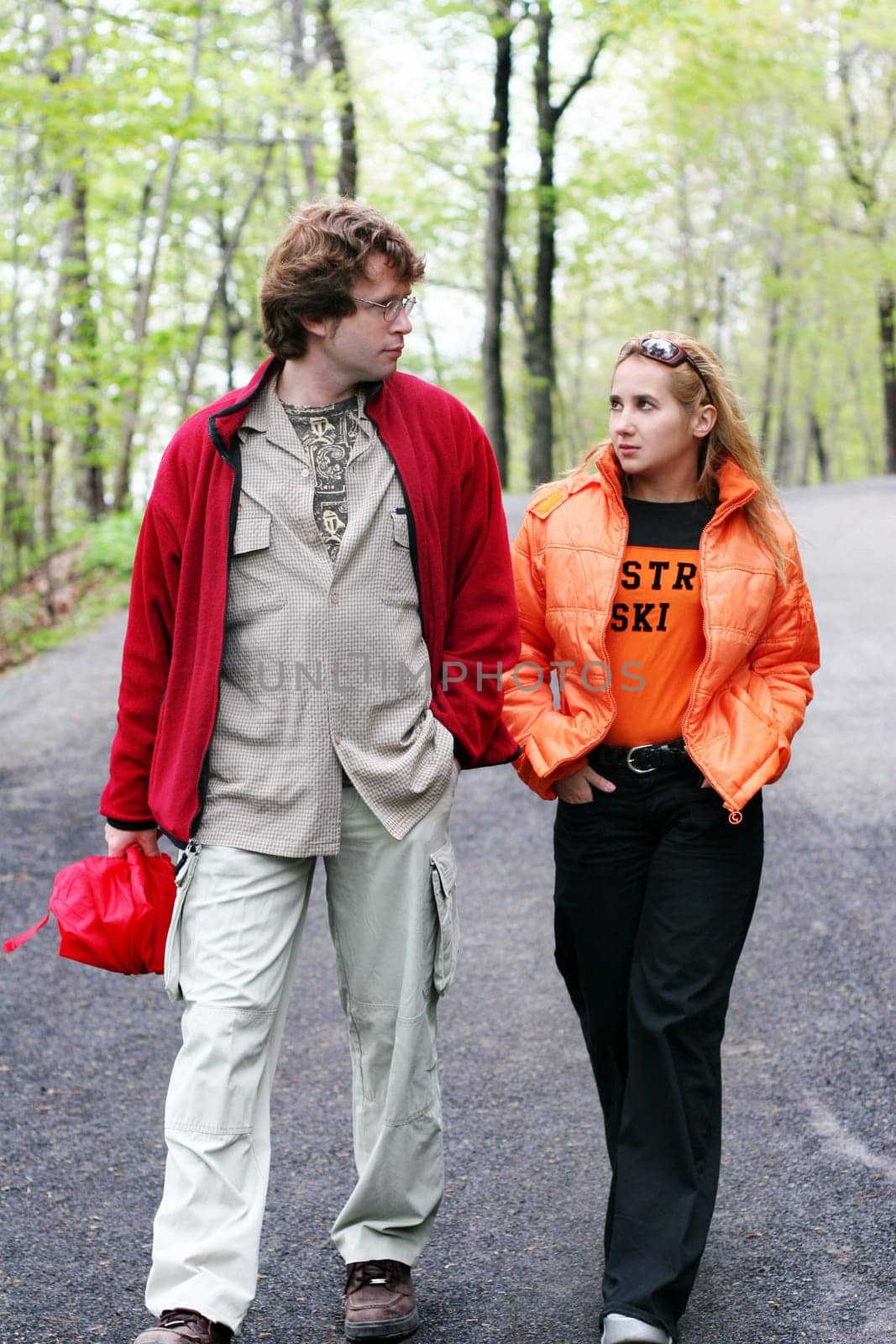 Romantic couple walking in a park on a rainy day