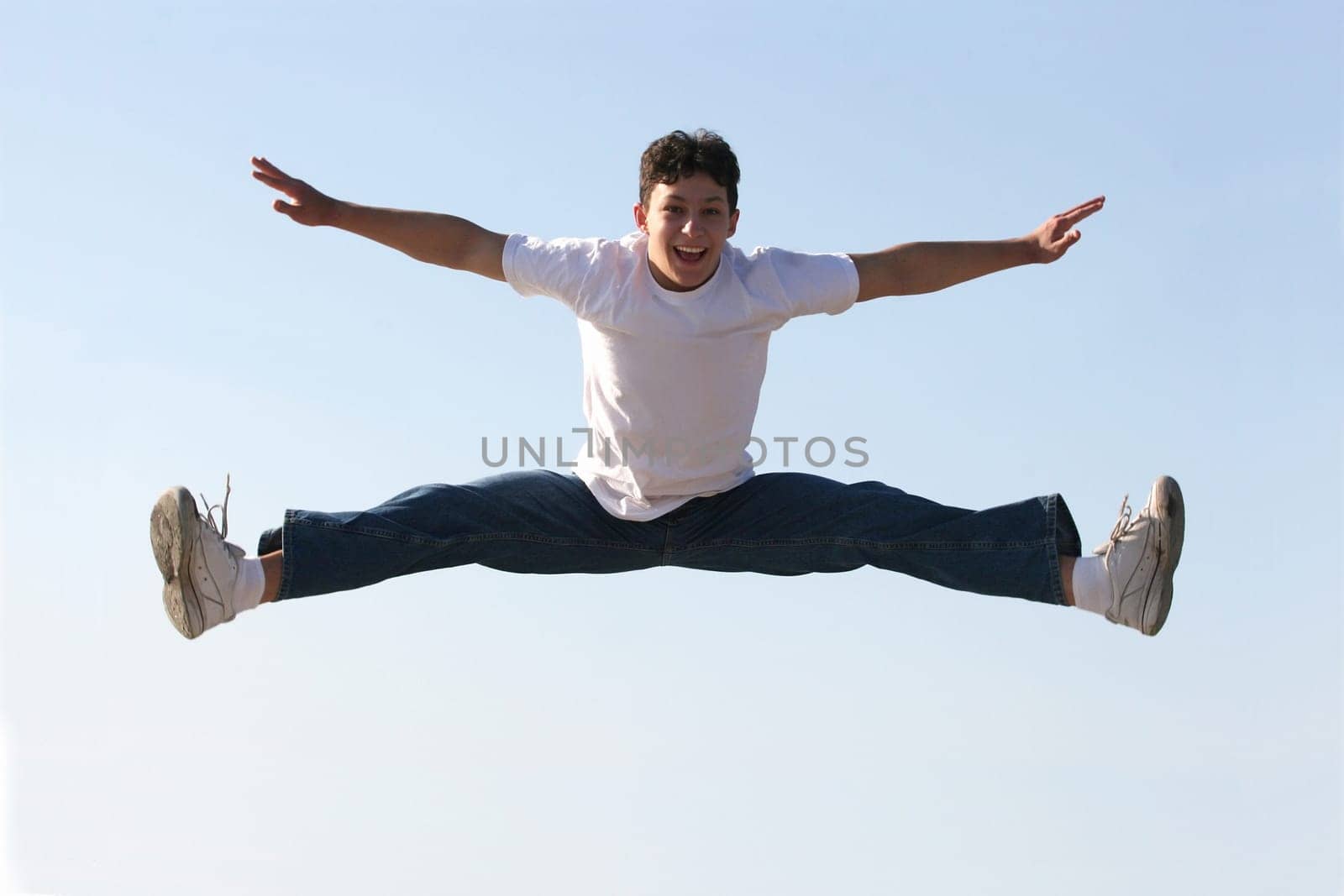 Boy making a split high in the air