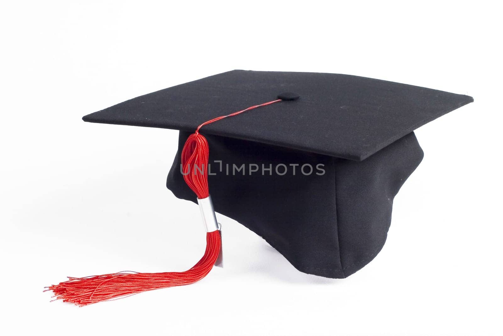 graduation cap with a red tassel isolated on white