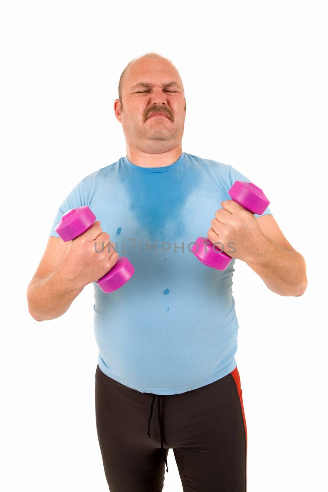 Sweating overweight man trying to work with hand weights