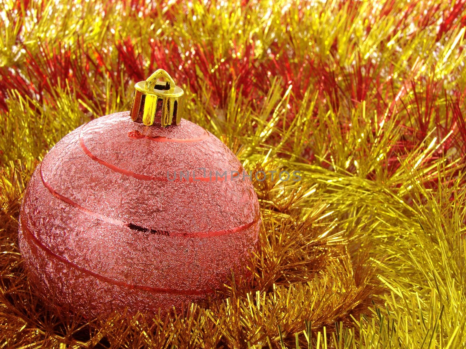 red christmas bauble with golden tinsel