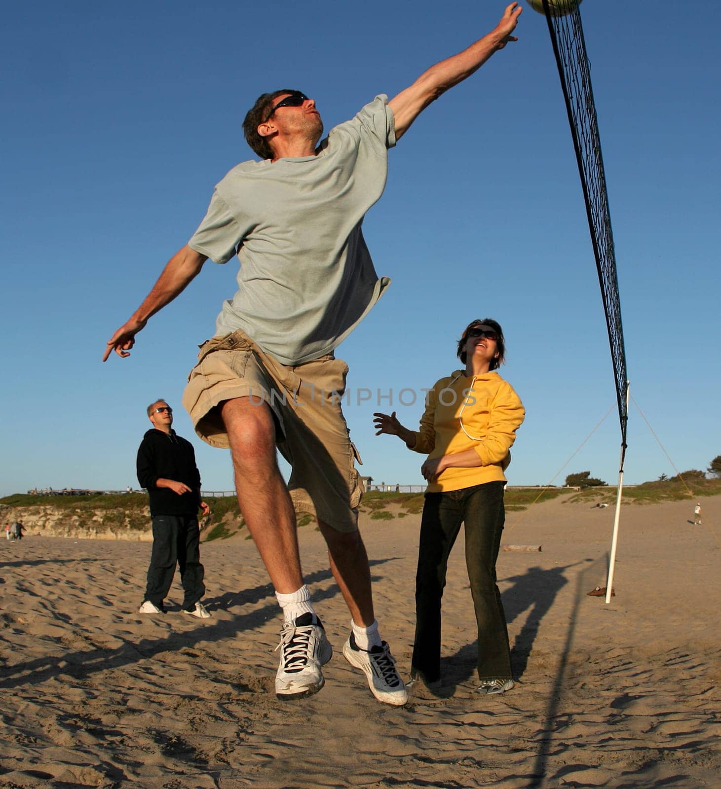People playing volleyball on the beach