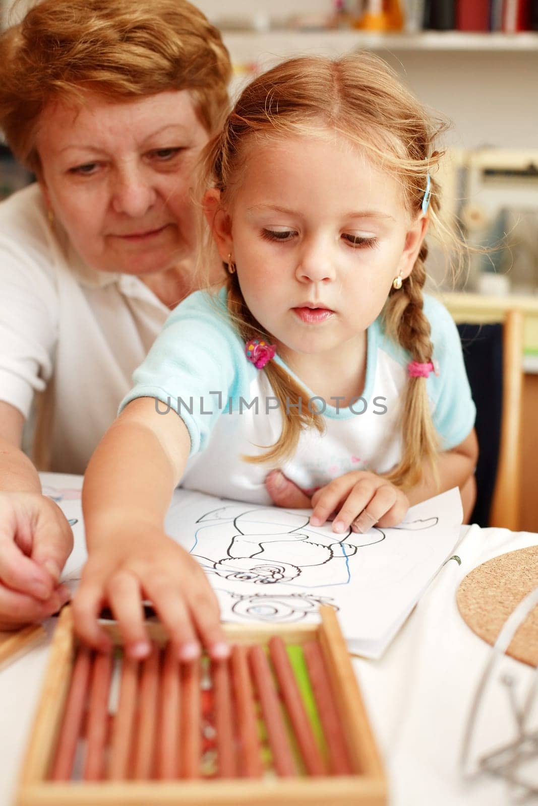 Grandma and grand-daughter painting