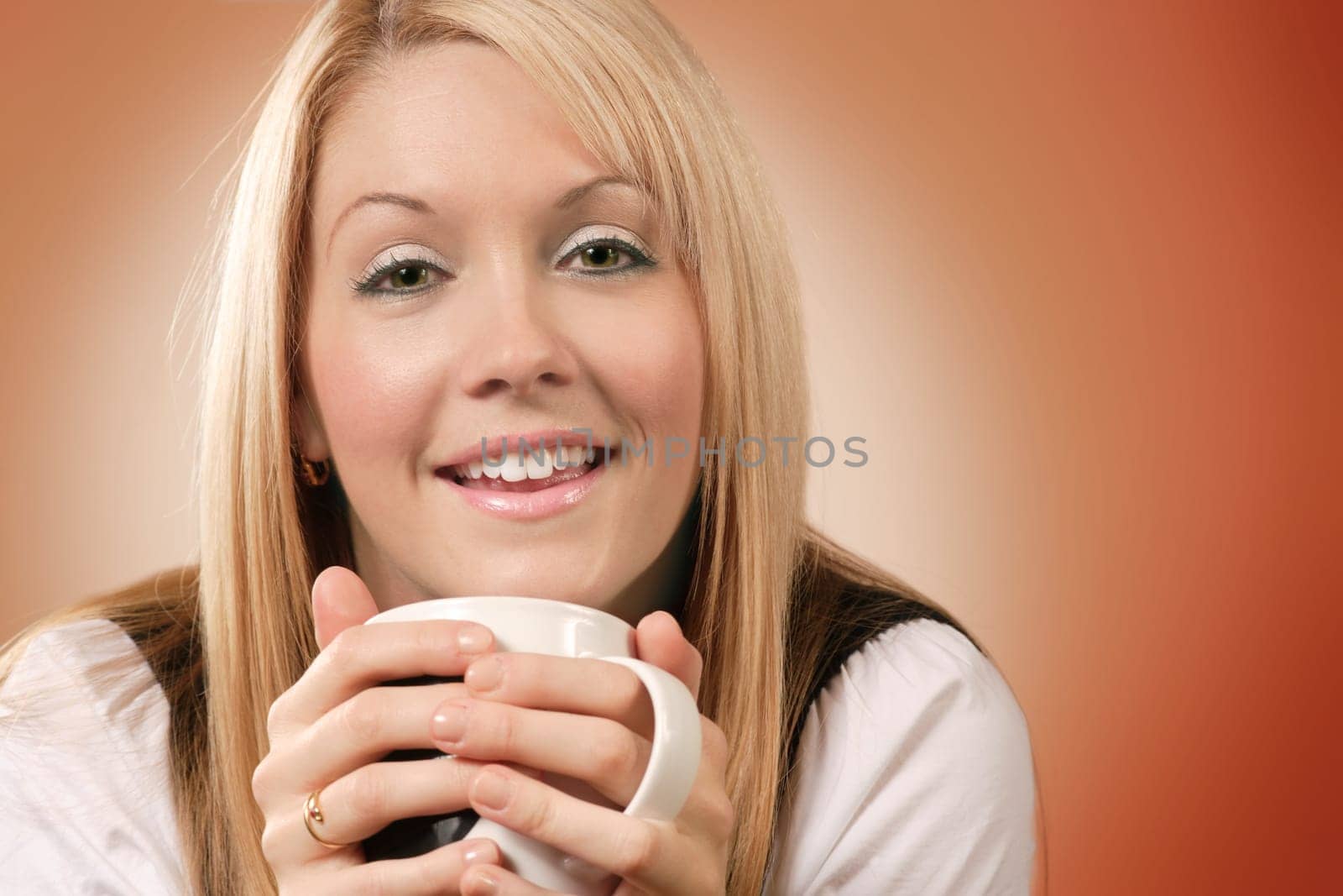 Happy and smiling female drinking coffee in an urban café.