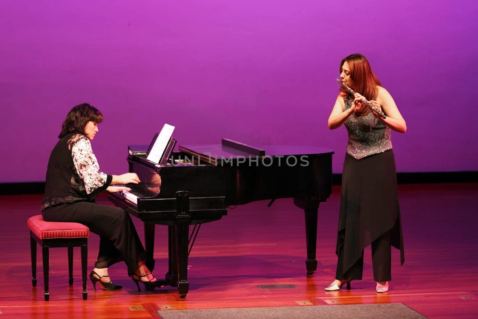 Flutist and pianist girls on stage