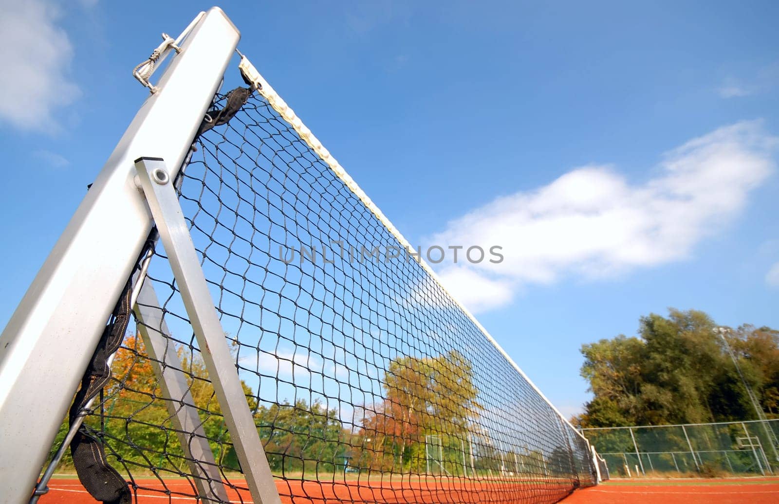 tennis court under blue sky, with focus on the net (wide angle)angel