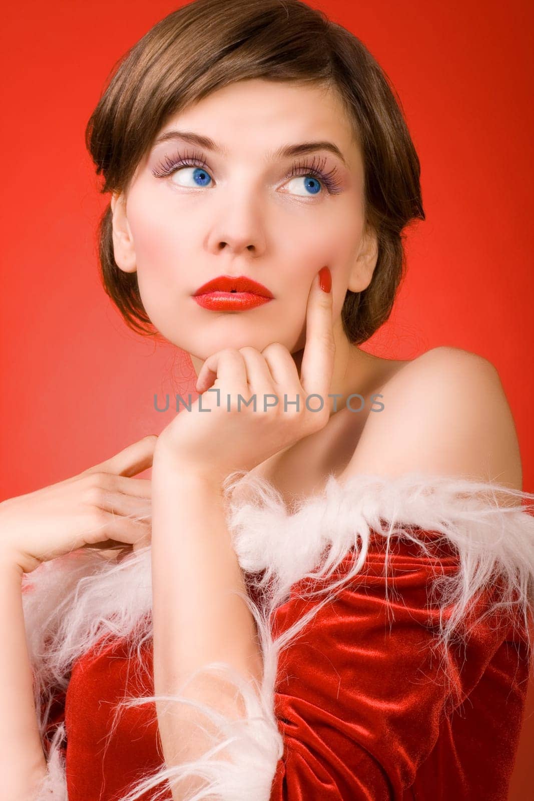 a christmas girl dressed in the red fur coat