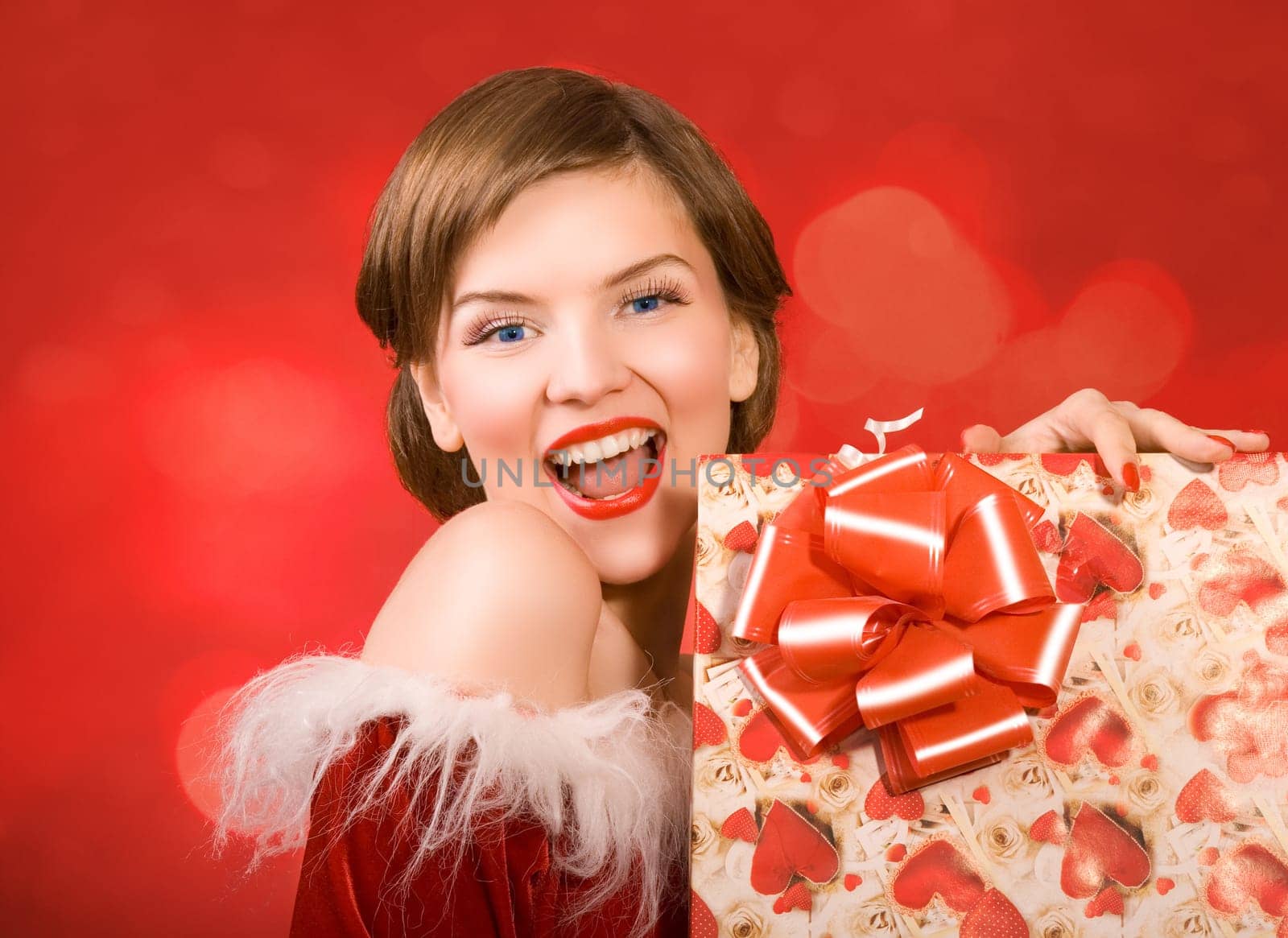 a christmas girl holding a gift box