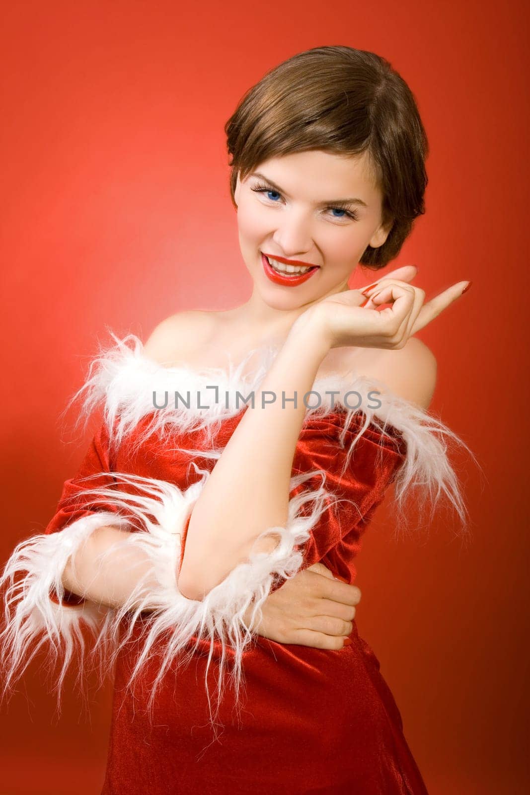 a christmas girl dressed in the red fur coat