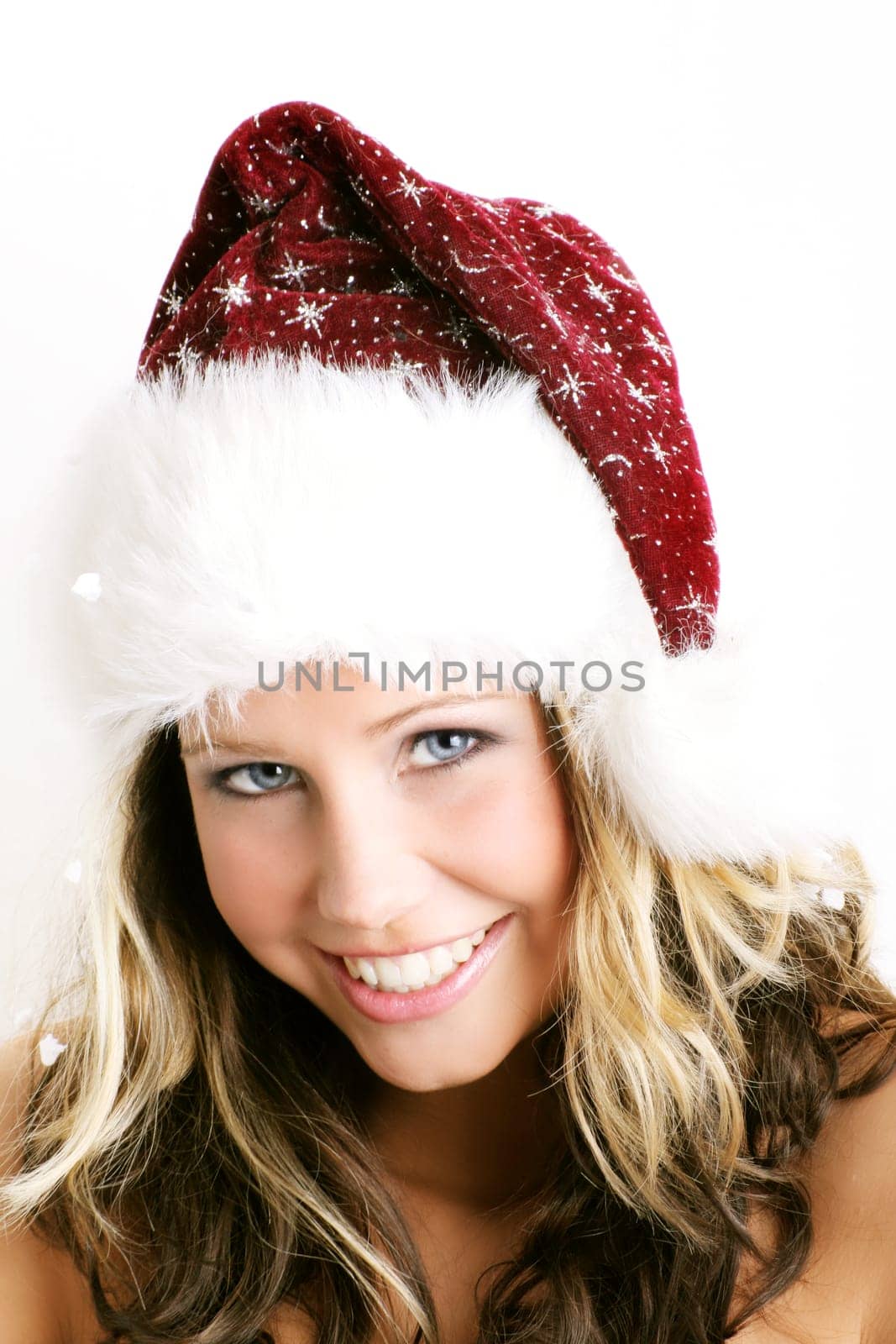 winter portrait of a beautiful young smiling woman with a christmas cap