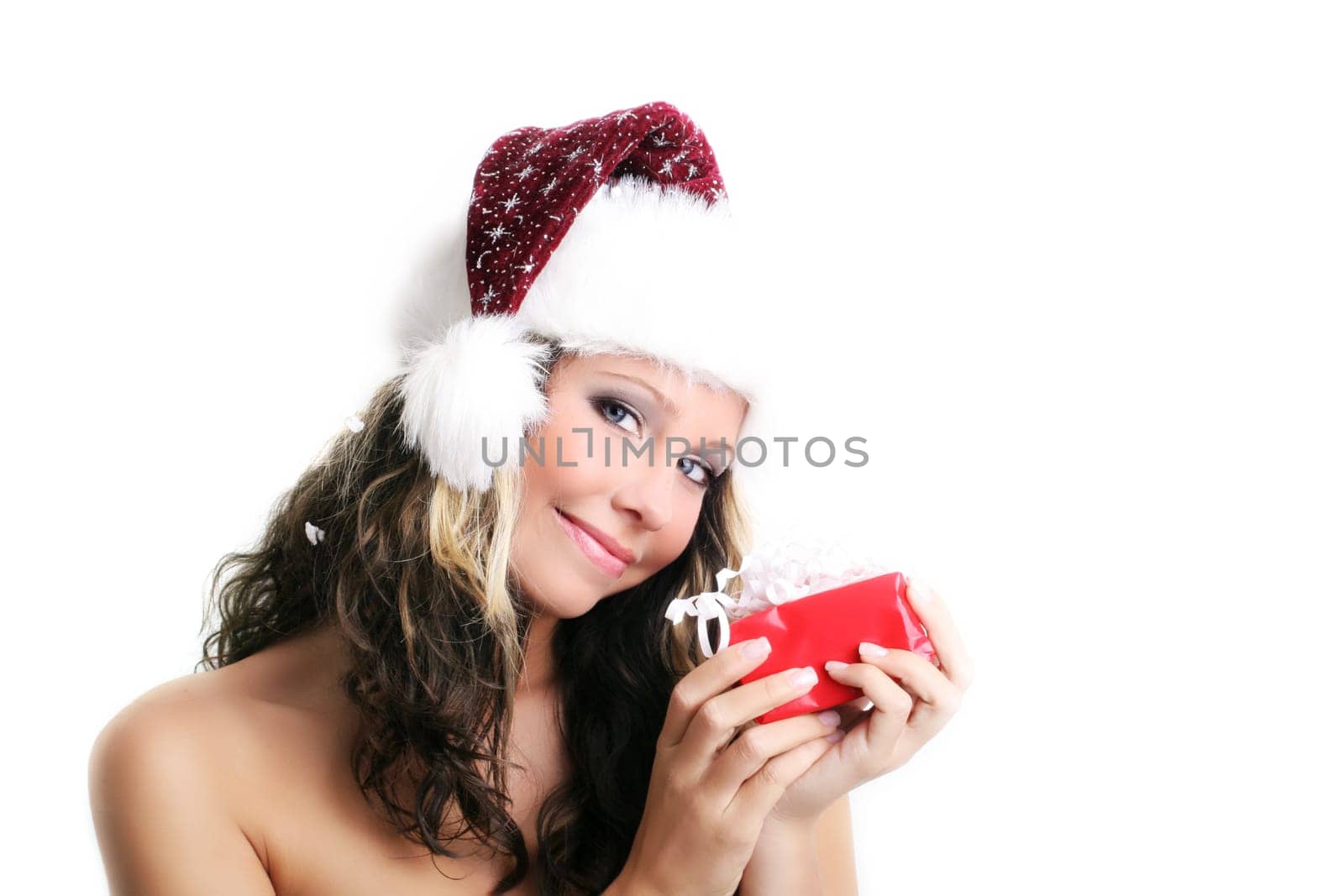 winter portrait of a beautiful young smiling woman with a gift in her hands
