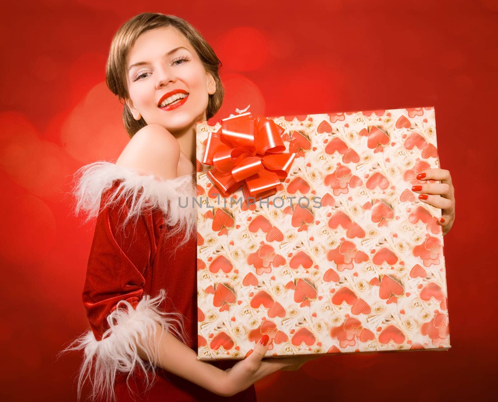 a christmas girl holding a gift box