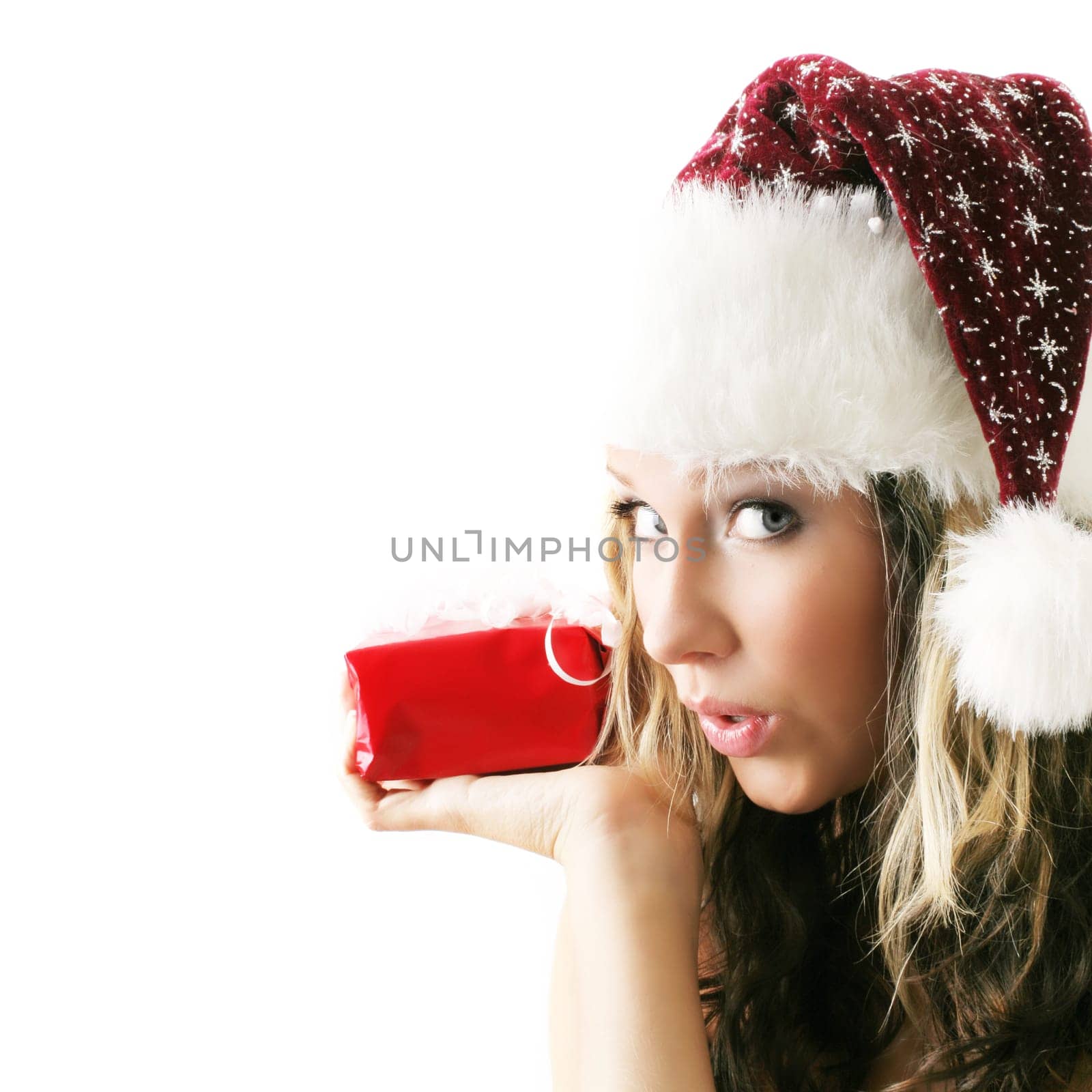 winter portrait of a beautiful young smiling woman with a gift in her hands