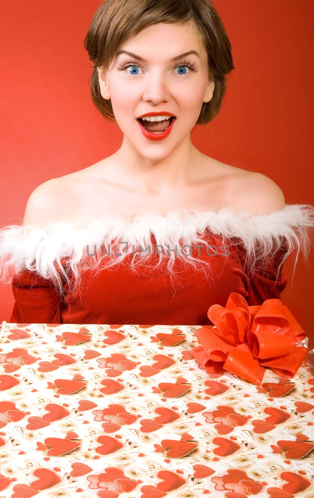 a christmas girl holding a gift box