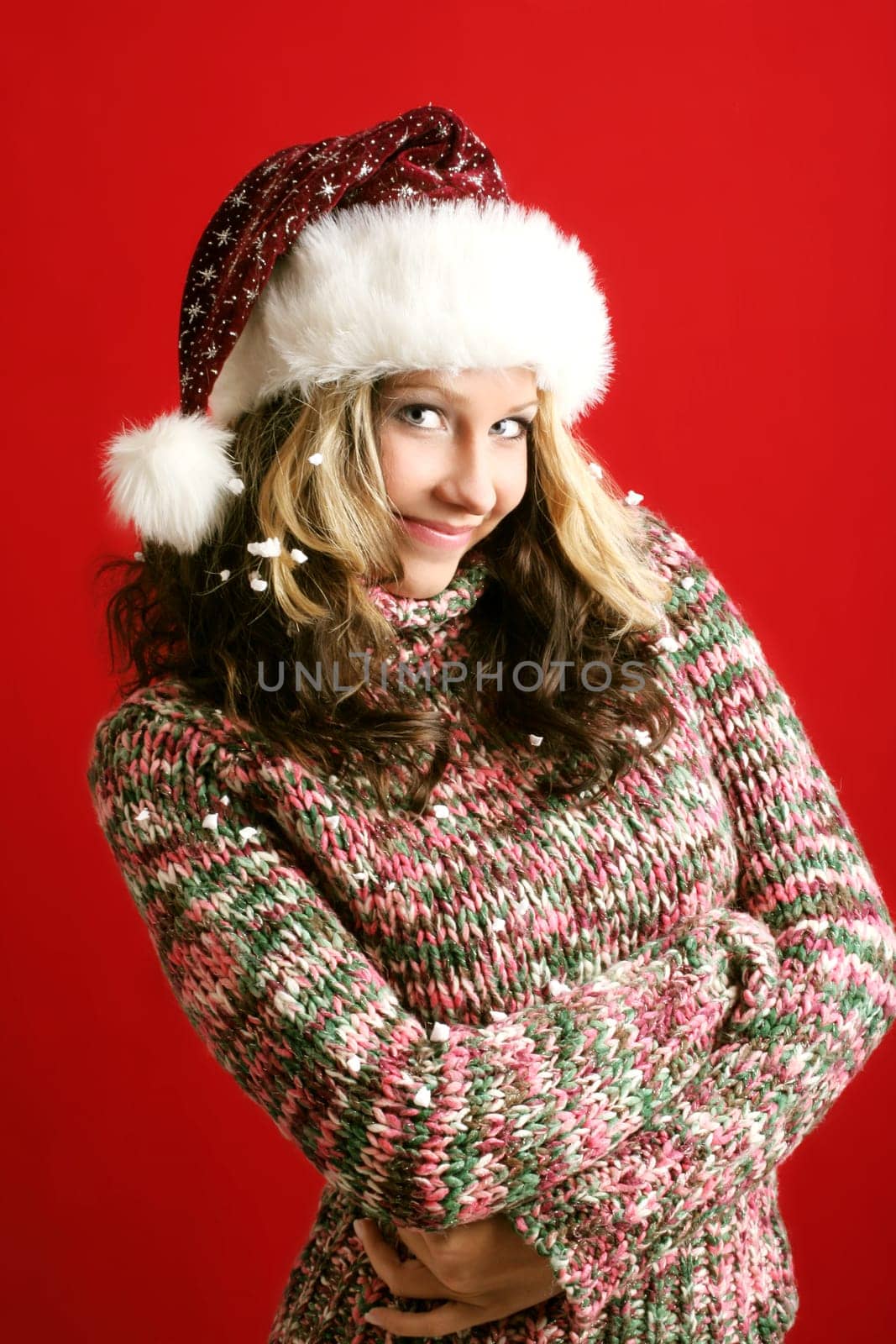 winter portrait of a beautiful young smiling woman with a christmas cap