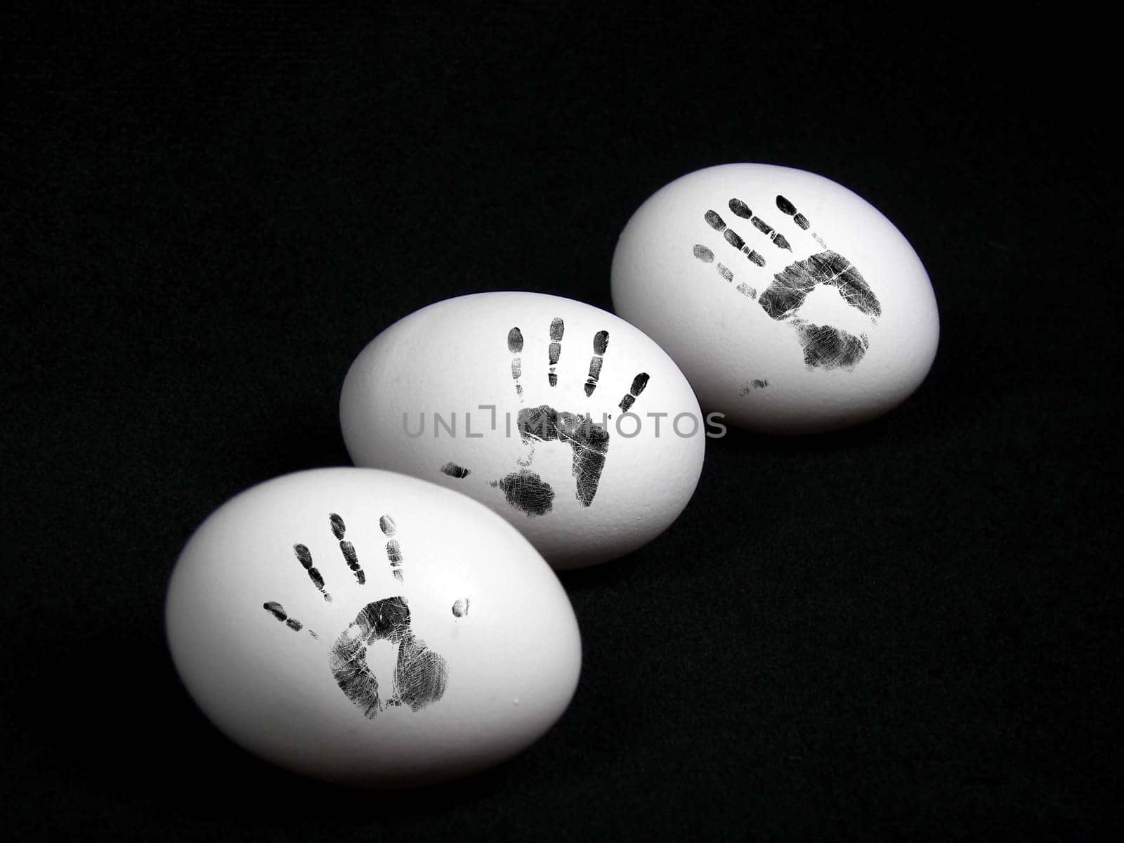 Hand prints on egg shells.
