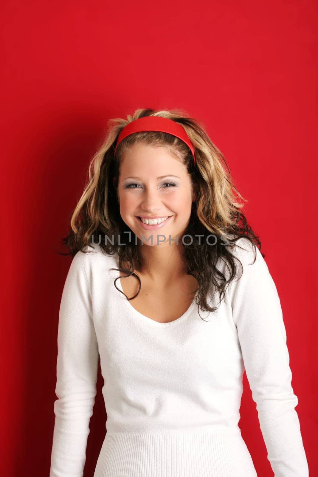 A young, attractive and happy woman is smiling