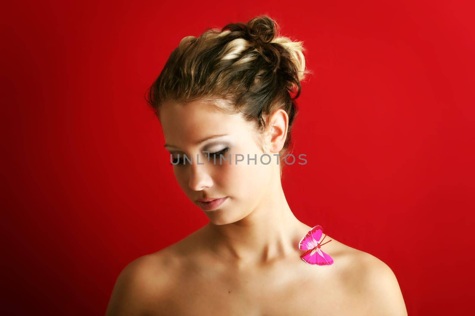 beauty portrait of a beautiful young woman with a butterfly on her shoulder