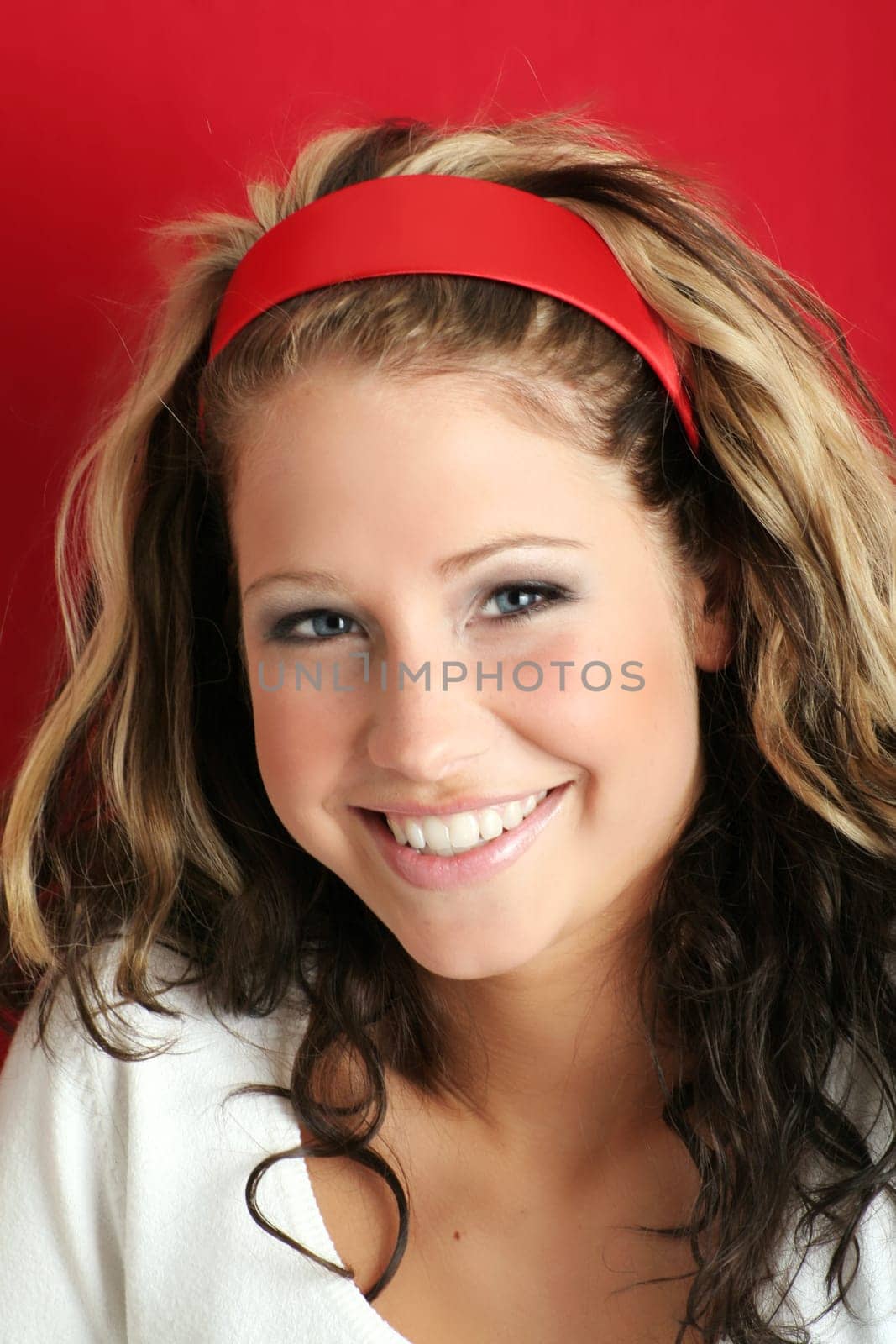 A young, attractive and happy woman is smiling