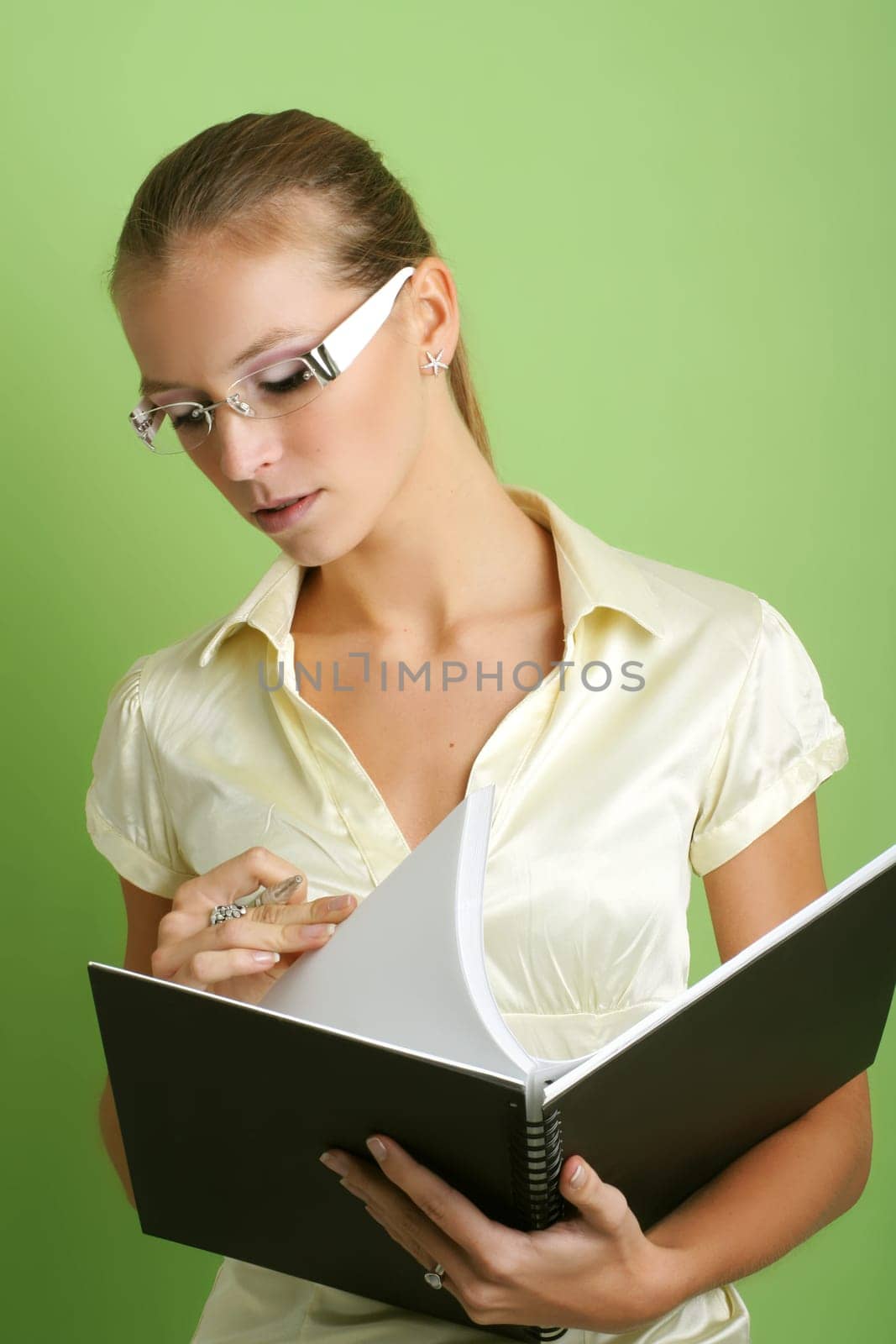 business portrait of a young and successful woman writing at a schedule