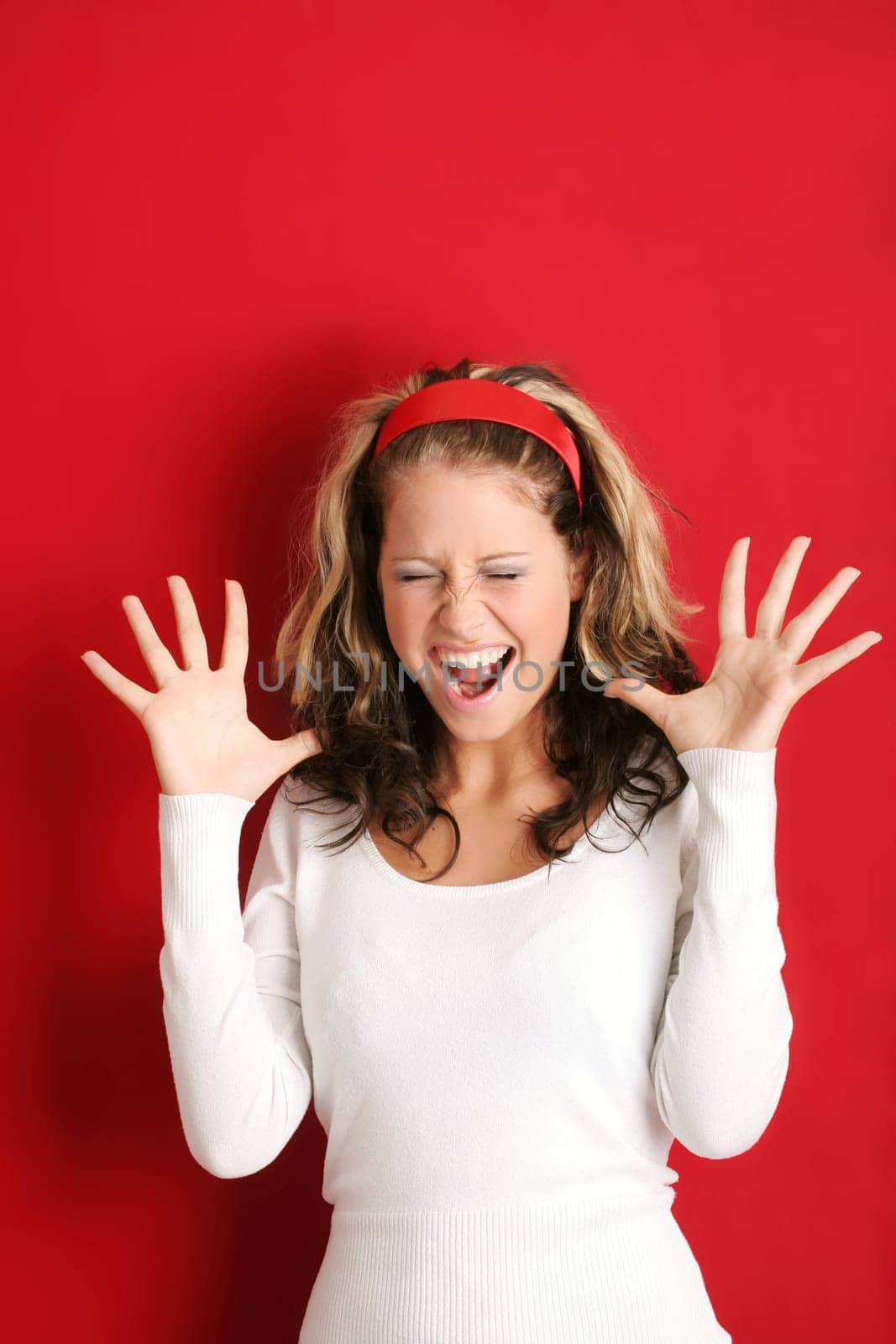 A young, attractive and happy woman is screaming