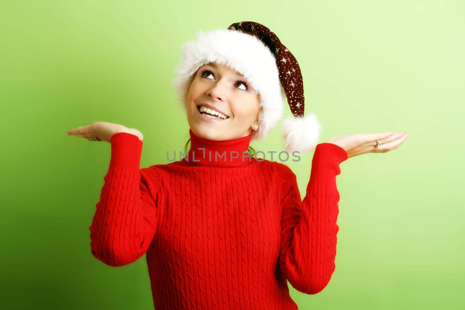 winter portrait of a beautiful young smiling woman with a christmas cap