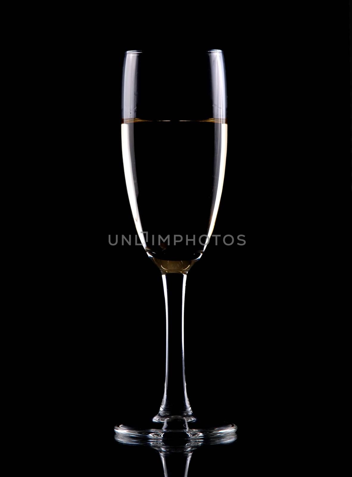 Glass of white wine isolated over black background,