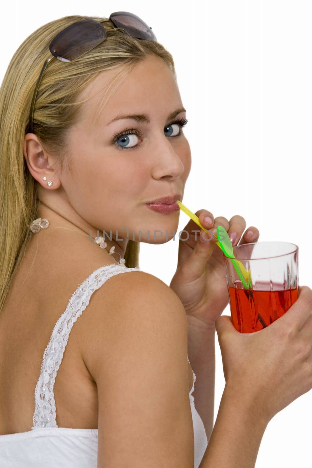 Isolated studio shot of a beautiful young woman drinking a bright red drink through a straw