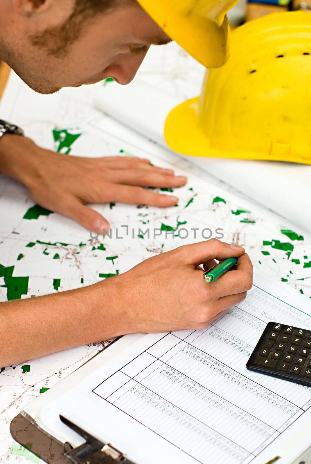 construction worker checking documents and maps