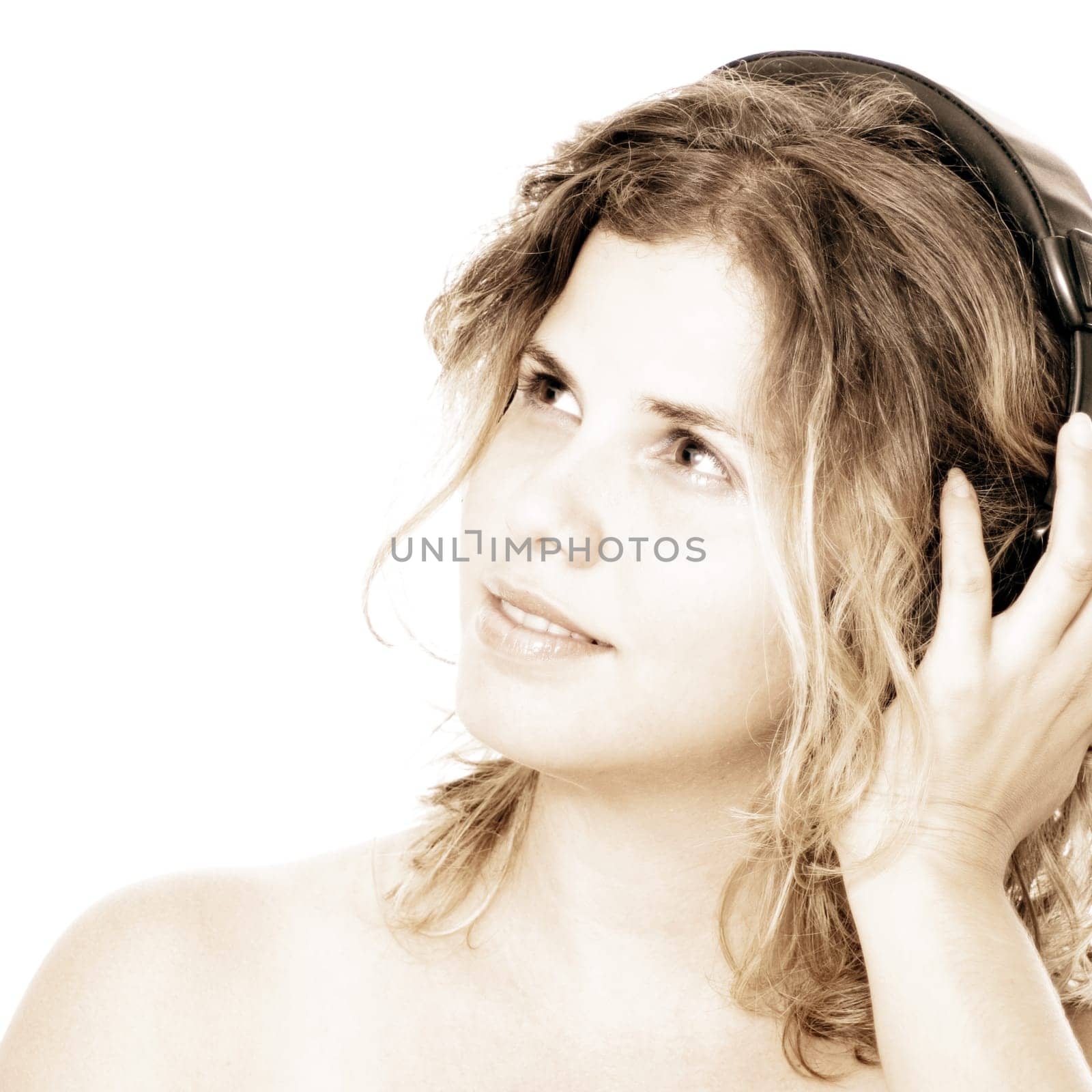 Young blond woman with headphones listening to music - isolated