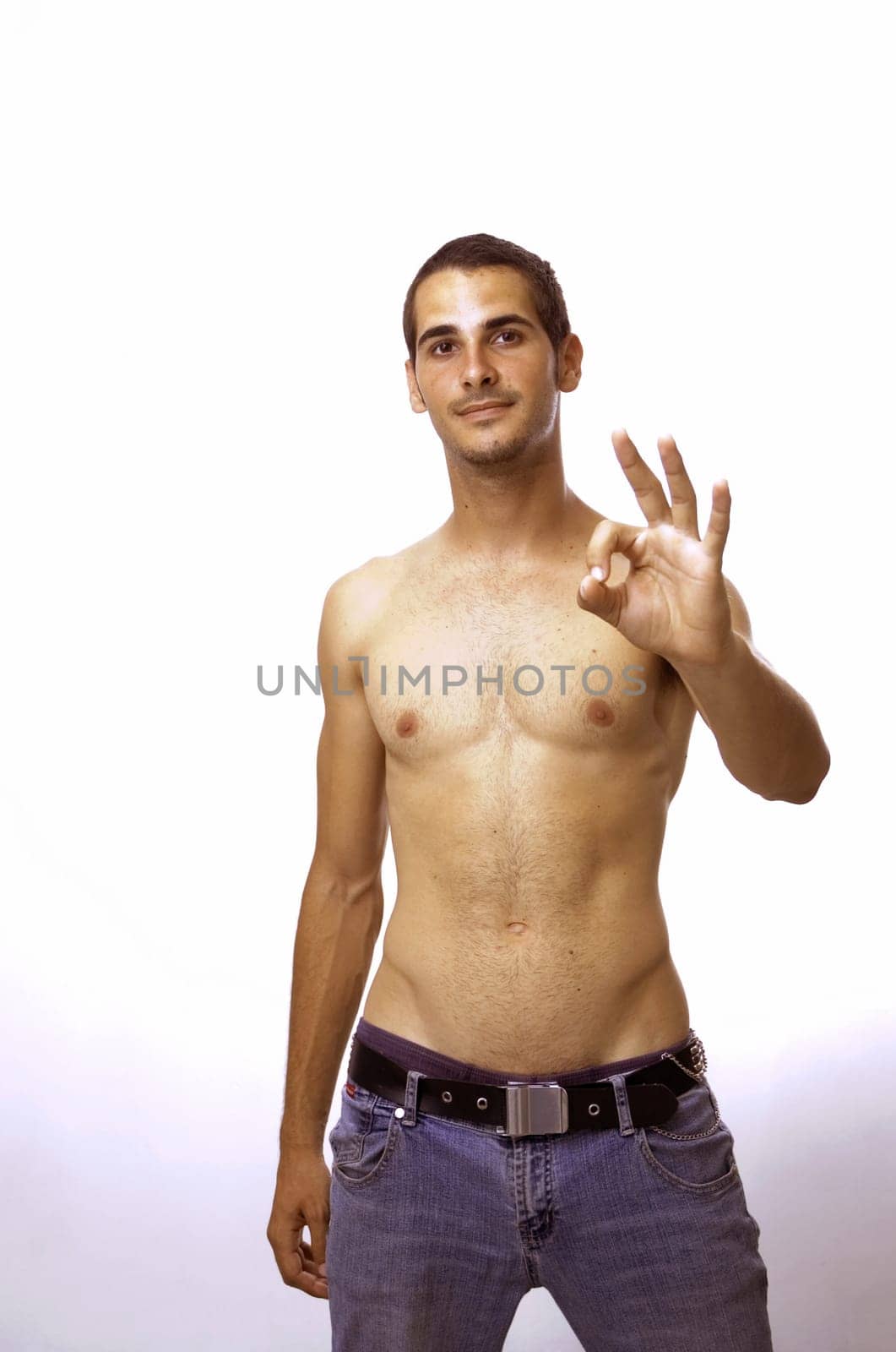 Portrait of young boy doing ok sign - isolated