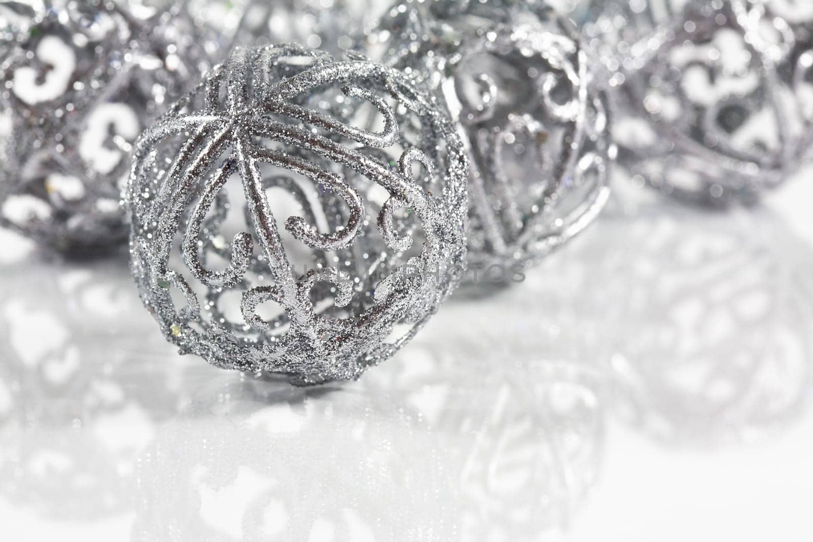 Silver balls on white background with small reflection