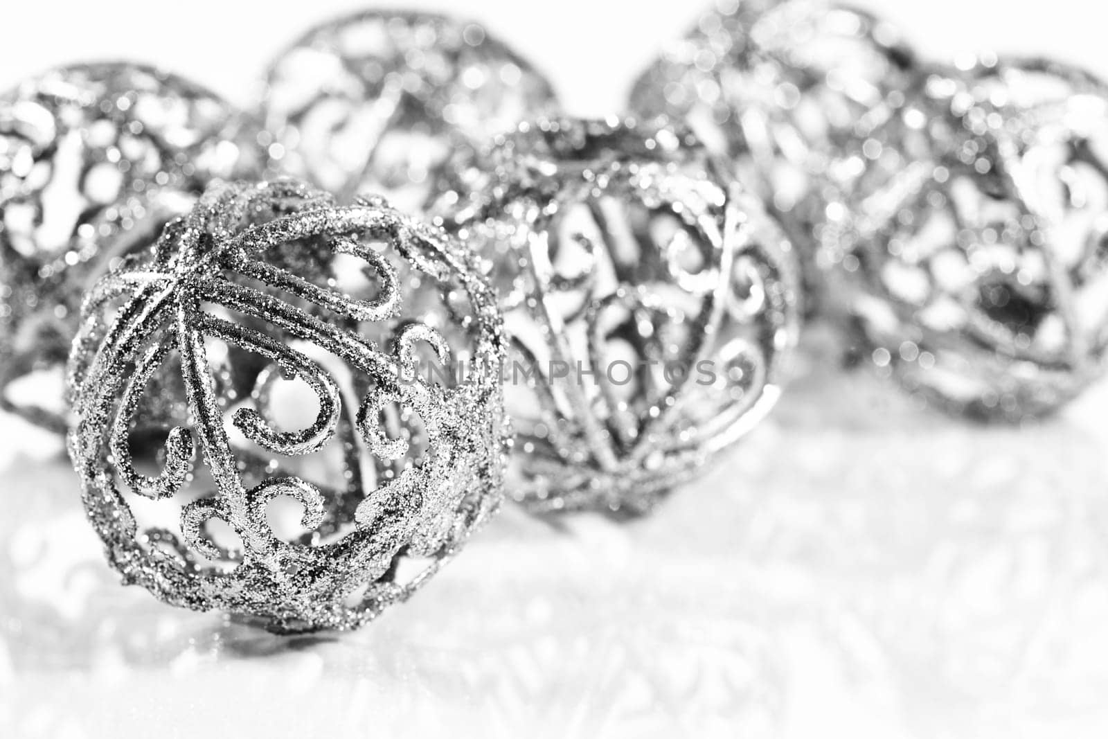 Silver balls on white background with small reflection