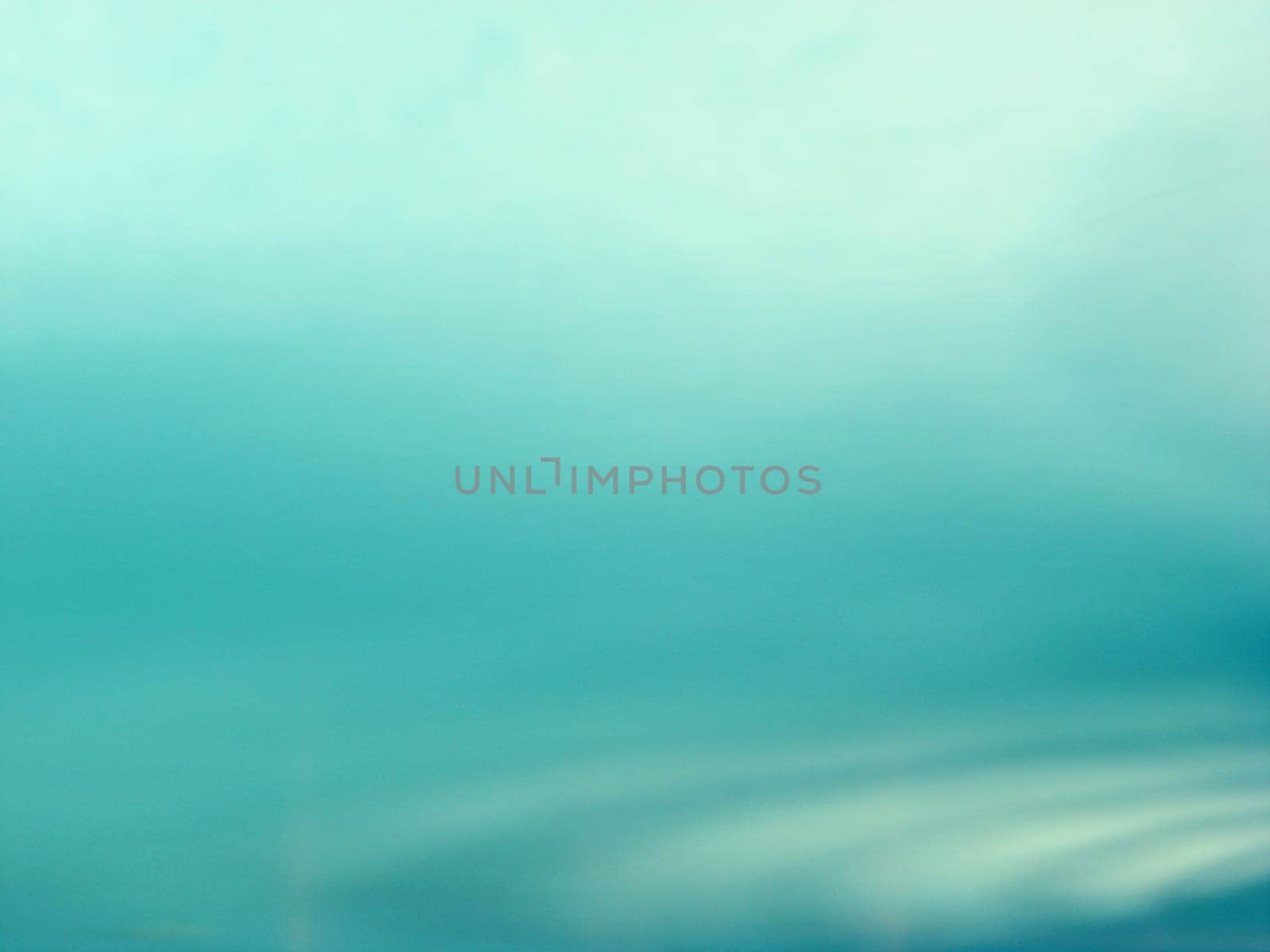 Tranquil ripples in aqua blue water.