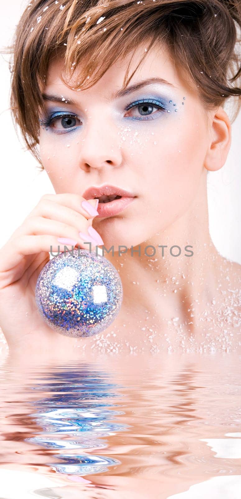 snow girl holding a christmas toy in her hand