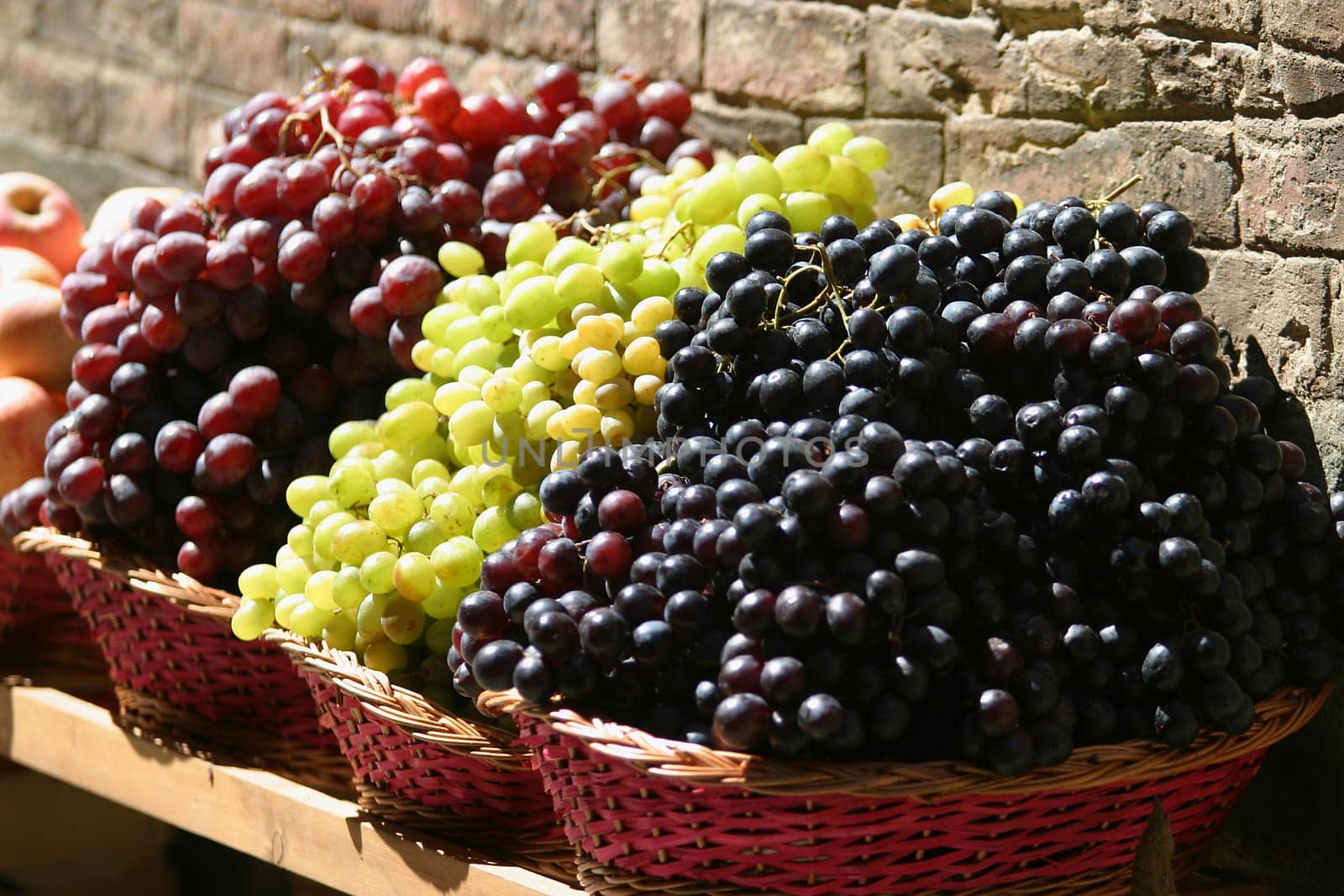 Grapes for sale at a market on the streets of Siena, Tuscany, Italy