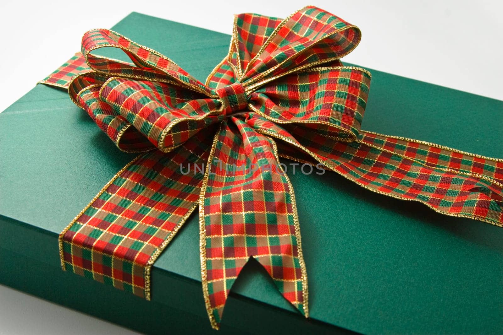 christmas present tied with ribbon on white background