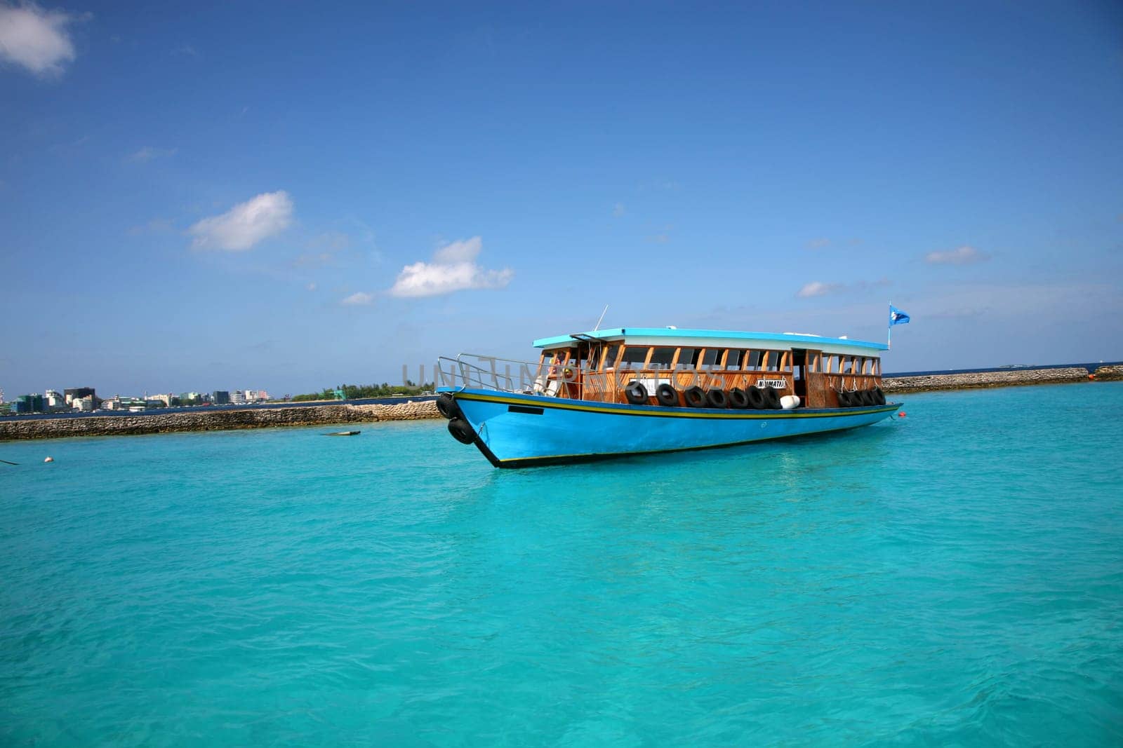 Ship in the Maldives cruising between the reef