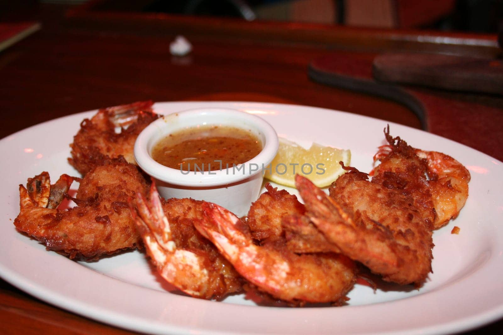a plate of coconut shrimp with dipping sauce