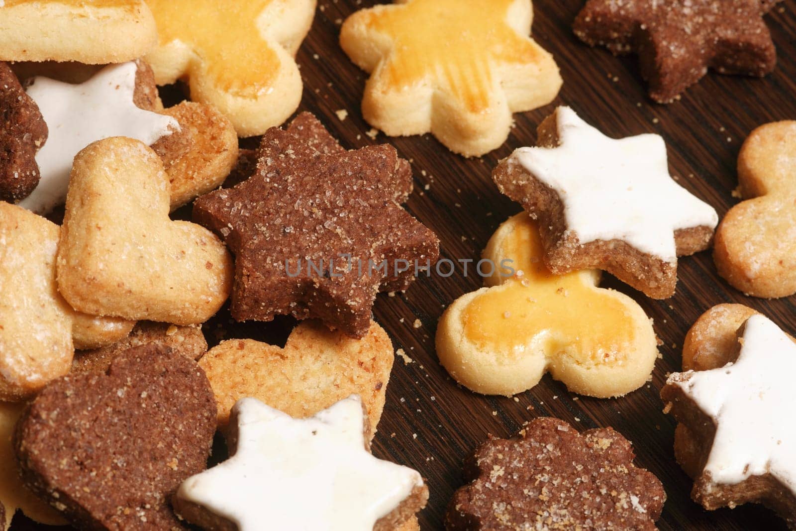Christmas cookies scattered on a wood table.