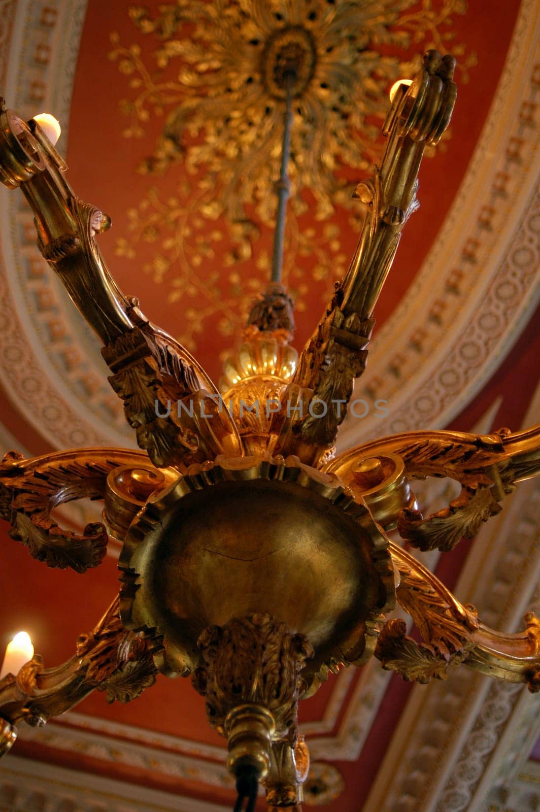 guilt chandelier hanging from ornate ceiling in 18th Century mansion in London