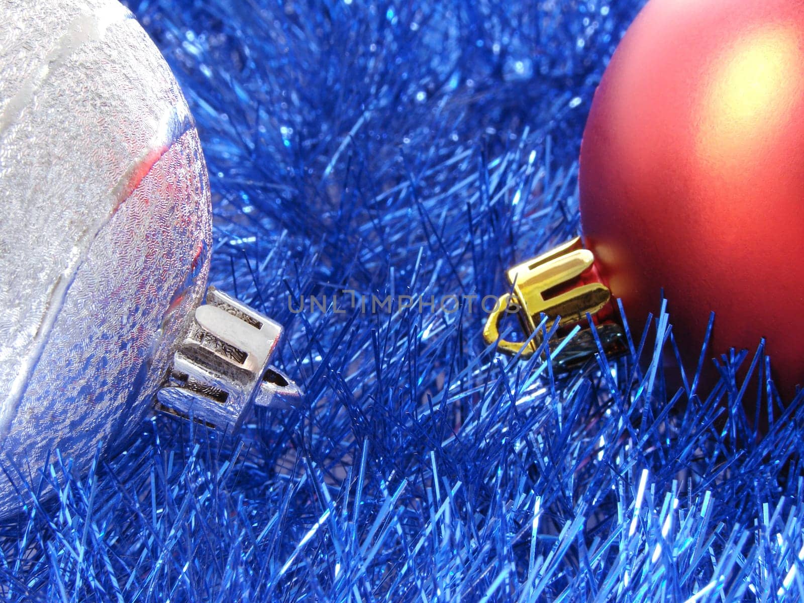 christmas design with colorful baubles and blue tinsel background