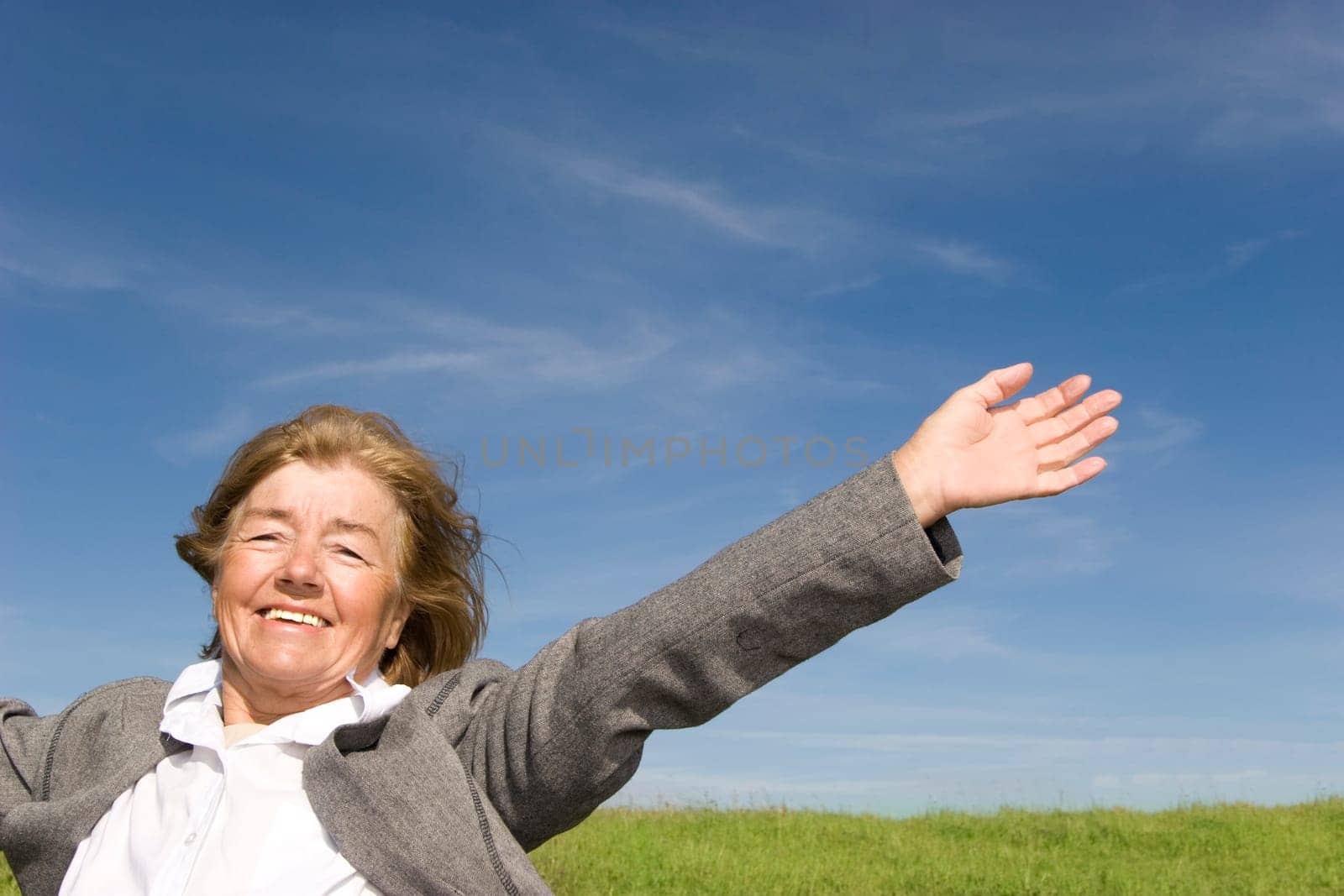 Beautiful, joyful mature woman on the meadow