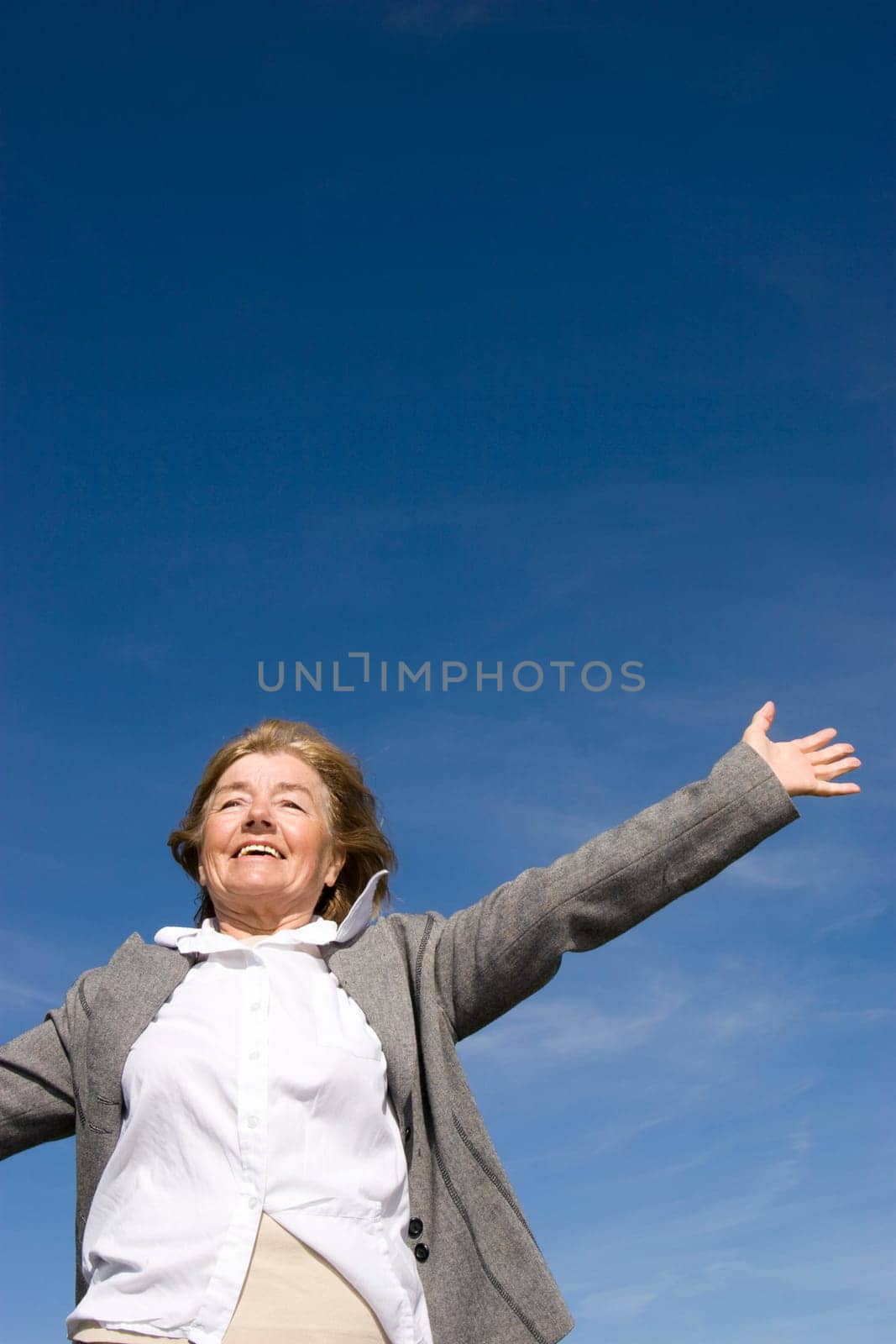 Beautiful, joyful mature woman on the meadow