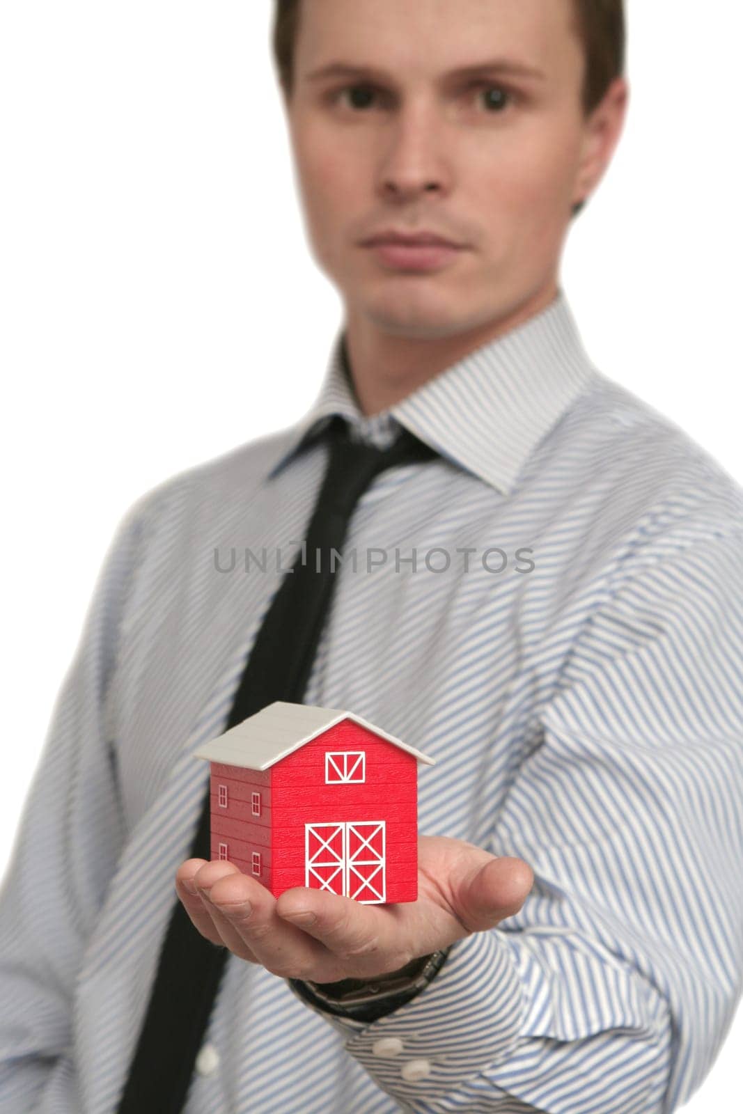 The man holds the red house in a hand