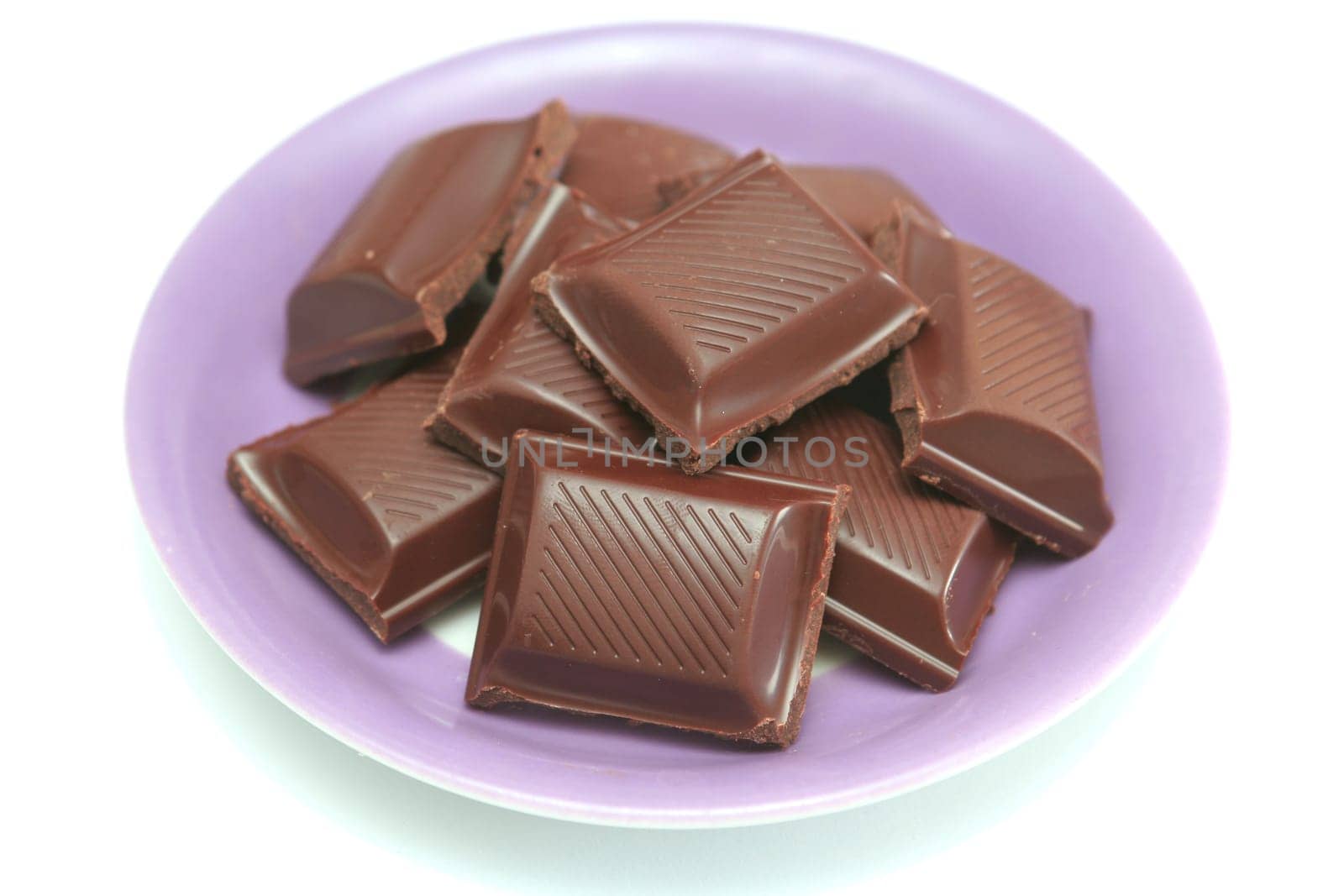It is a lot of segments of chocolate lay on a plate