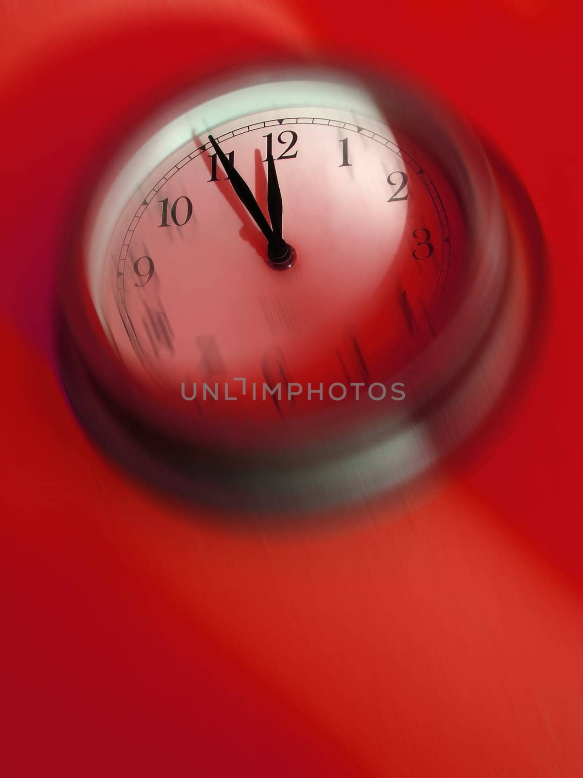 Blurred clock about to strike midnight