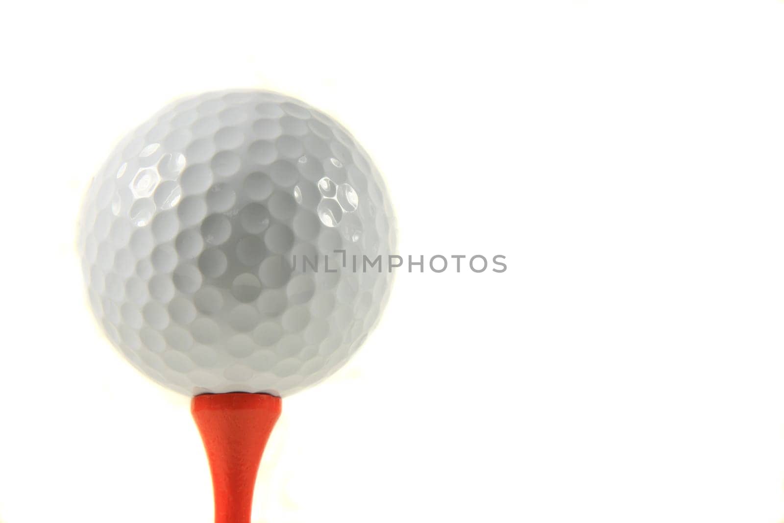 Isolation of a Golf Ball on an Orange Tee on White Background